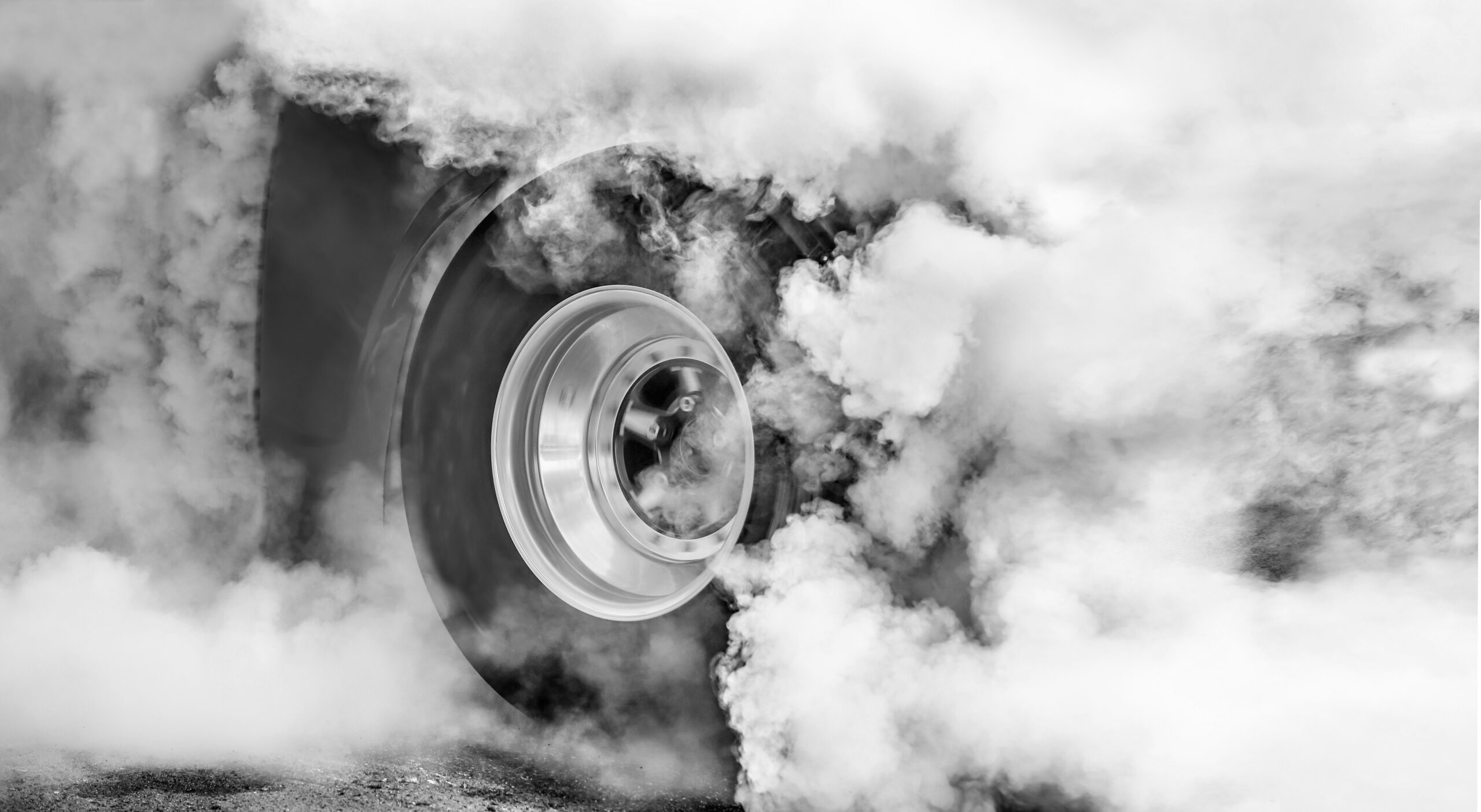 Drag racing car burns rubber off its tires in preparation for the race